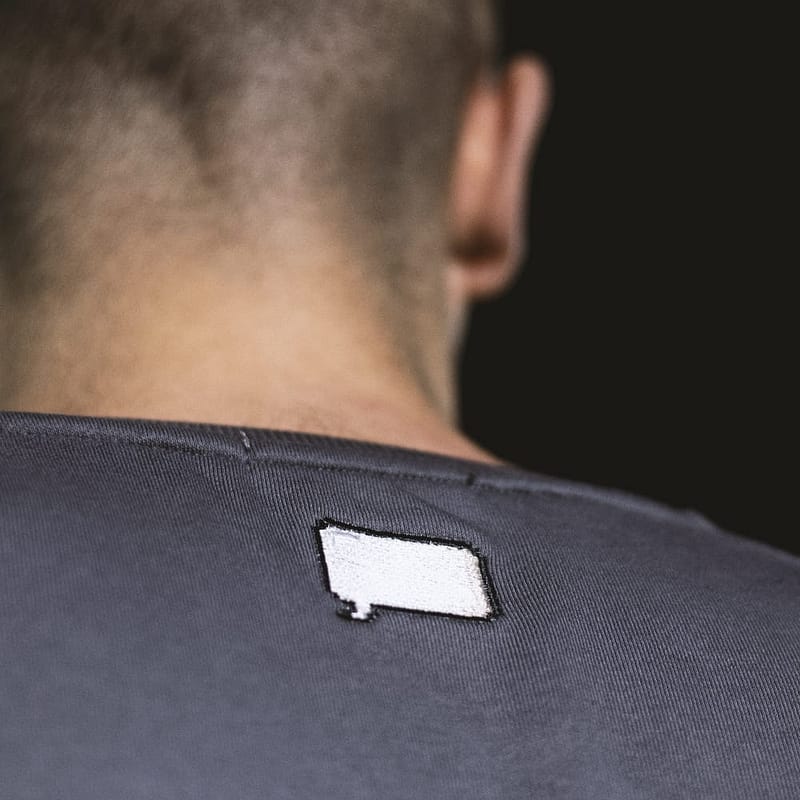 Transform your wardrobe with our French Terry sweatshirt, featuring a classic gray color and eye-catching speech bubble embroidery."